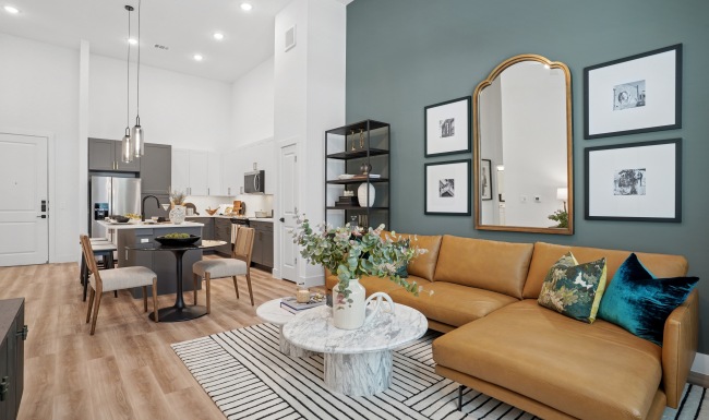 Spacious living room with hardwood style floor inside apartment homes at Copper Bishop Arts